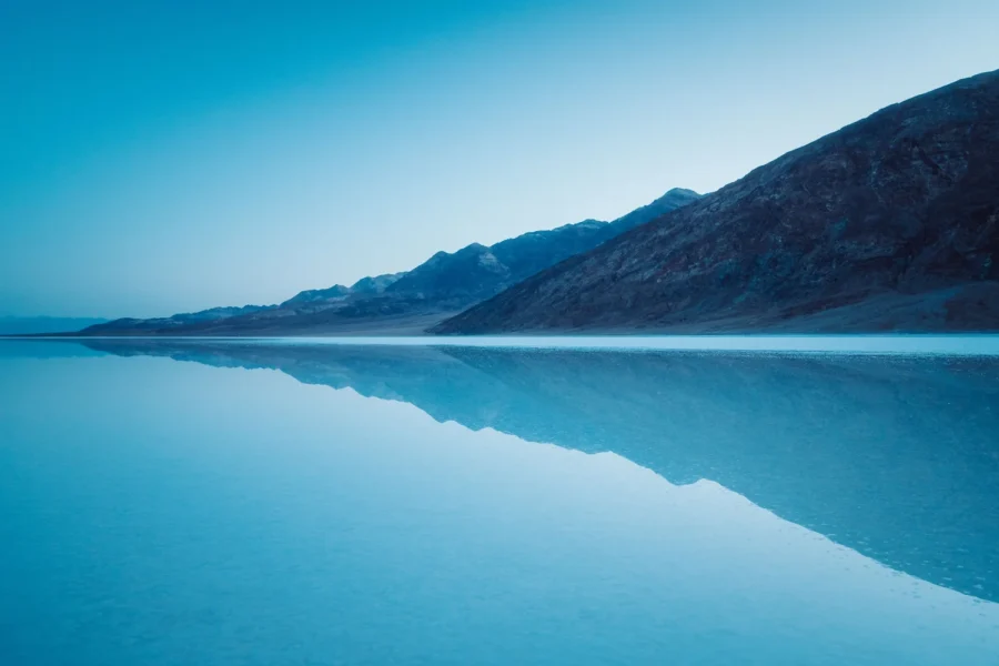 Pre-dawn blue hour over the flooded Badwater Basin at Lake Manly, Death Valley