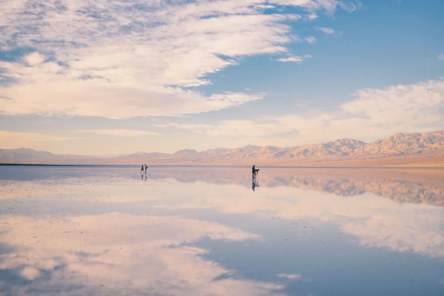 Cloudscape mirrored in the floodwater at Lake Manly just after sunrise, Badwater Basin, Death Valley