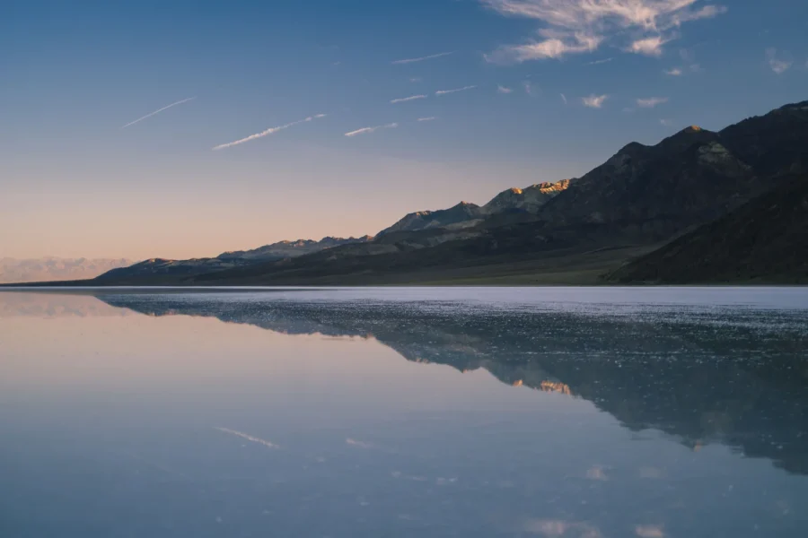 First light on the peaks above Lake Manly with Badwater Basin still deep in shadow, Death Valley
